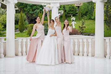 Bridesmaids and bride celebrate together in a scenic outdoor wedding venue