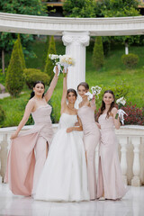 Bridesmaids celebrating joyfully during an outdoor wedding ceremony in springtime
