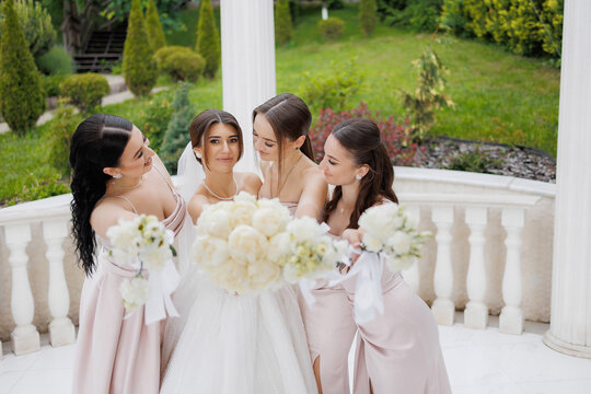 Bridal party celebrating in a garden setting before the wedding ceremony in springtime - Powered by Adobe
