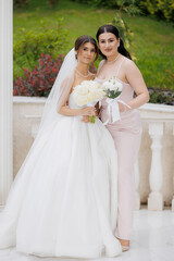 Wedding celebration with bride and maid of honor in beautiful garden setting during daylight