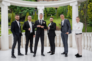 Friends celebrate together at a wedding in a scenic garden setting
