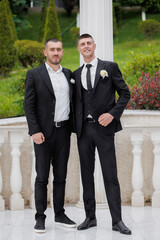 Friends celebrate together during a formal event at a beautiful outdoor venue