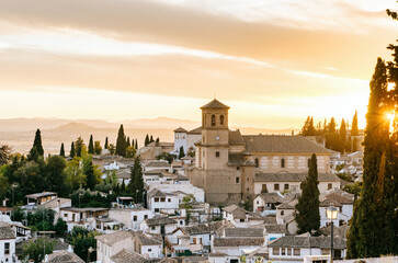 Fototapeta premium Sunset view of Granada from Mirador de la Cruz de Rauda with Iglesia de San Cristobal and city rooftops