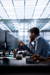 African american programmer doing checkup to prolong data center electronics life span and avoid...