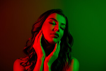 Close up photo of attractive lovely girl model enjoying soft face skin isolated multicolor red green neon background