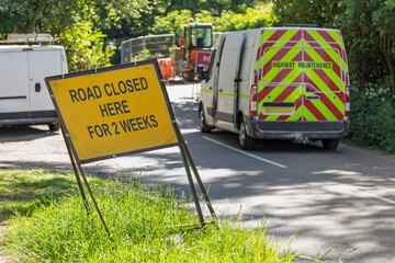 Road Closed Sign with Highway Maintenance Vehicles in UK