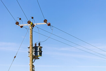 Utility Pole with Transformer Against a Clear Blue Sky