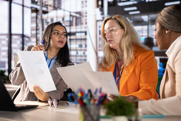 Diverse team of empowered women executives discussing corporate strategy and business growth....