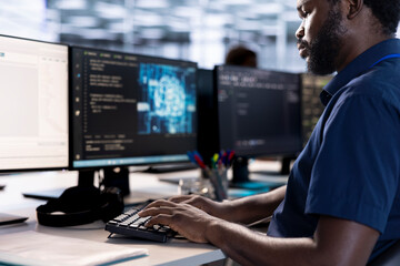 System administrator reconfiguring artificial intelligence server farm to optimize it for data processing requirements of customers. AI expert working to ensure data center gear operates efficiently