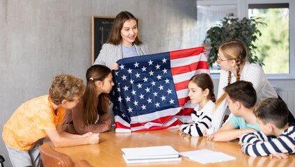 The teacher talks about the country and the national flag of United States of America in a...