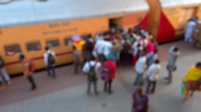 Bokeh view of people boarding the train in Hyderabad, India. Blurred background footage.