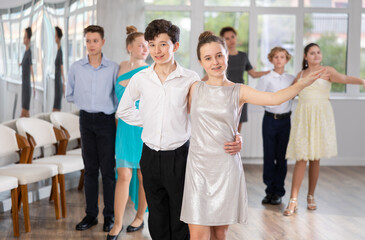 Fototapeta premium Pair dances - girls and guys in festive attire dance tango or samba