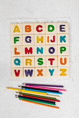 English Alphabet. Colored English letters. With colored pencils. Light background. Top view