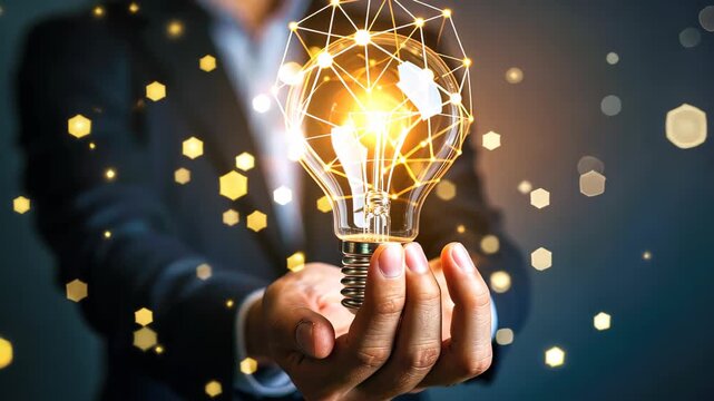 Illuminating Innovation: A light bulb shines brilliantly in a hand, symbolizing breakthrough idea and connected technology. A network of glowing node surrounds it.
