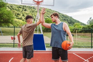 Friends basketball teenage players stand on the court with ball