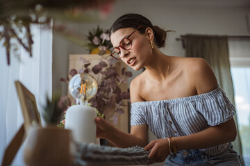 adult woman meticulously cleans dust from furniture in the living room