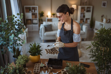 woman gardener florist cultivate and transplantation plants at home