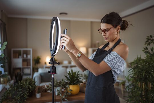 woman gardener prepare and set up equipment for record video at home