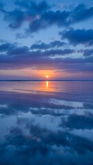Beautiful sunset over calm water with cloud reflections for peaceful background art