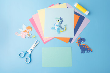 Top view of colorful craft layout with paper dragons for DIY brands, e-learning visuals, craft...