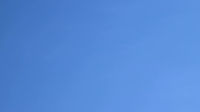 Timelapse blue sky with passing white clouds. Fluffy cirrus clouds moving. Nature background. Time lapse 4k footage.