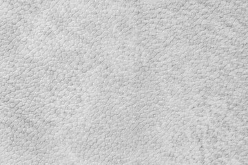 Fototapeta premium Detailed close up, macro of white synthetic suede leather texture, faux leather, leatherette. Background for design, fashion, upholstery material visuals. Natural grain structure, soft look.