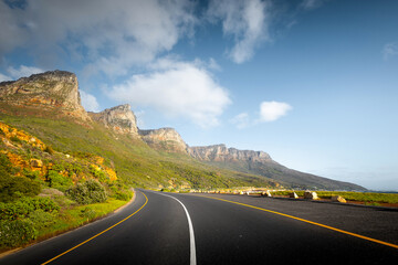 Scenic Coastal Road through Cape Town Suburbs with Mountains and Ocean View