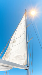 Obraz premium Sailboat mast against clear blue sky with bright sun overhead