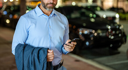 Businessman walking night city. Business man chat on phone outdoor. Businessman chatting on phone...