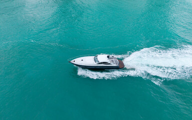 Aerial view luxury motorboat in sea. Summer sea vacation. Boat trip. Luxury lifestyle and traveling. Sea boat go to yacht marina. Yachting and boating marina. Yacht boat sailing