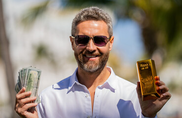Financial success and saving. Successful rich man with gold and money. Business success man with...