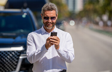 Business man chat on phone outdoor. Businessman chatting on phone. Businessman using smartphone....