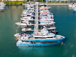 Aerial view of luxury yachts docked at marina. Top-down drone shot of yachts. Boats and sailboats...