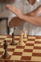 Close up of hands of middle aged caucasian man playing chess. 
