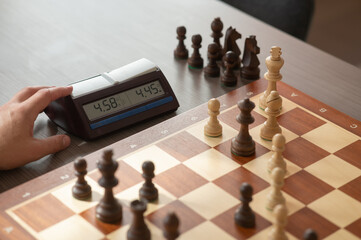 Close up of hands of middle aged caucasian man playing chess. 
