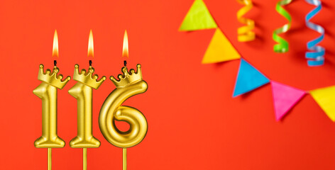 Number 116 birthday candle on an orange background with pennants