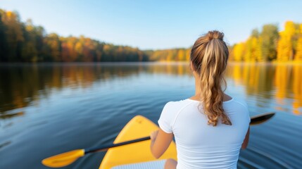 Morning tranquility on a paddle board in a foggy lakeside landscape
