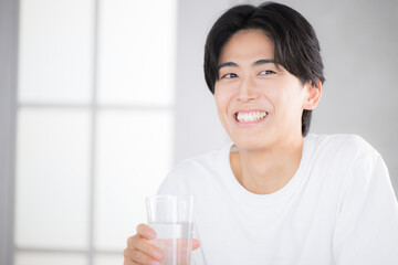 朝に水を飲む男性　水分補給などのクローズアップ