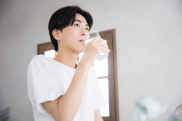 Man drinking water in the morning Close-up of hydration, etc.