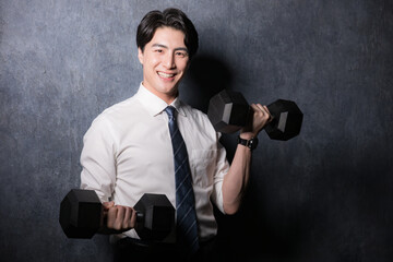Man in suit doing strength training with dumbbells Gray bag camera eye Salesman is a strength...