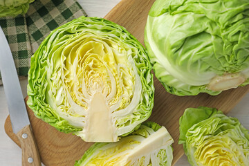 Fresh whole and cut cabbages on table, flat lay