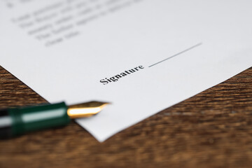 Notary document and fountain pen on wooden table, selective focus