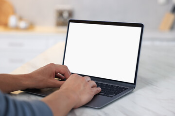 Man using laptop at white marble table indoors, closeup