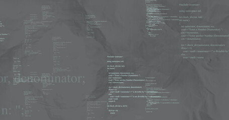 Displaying central cluster of white C++ code forming block on crumpled gray backdrop, coding theme