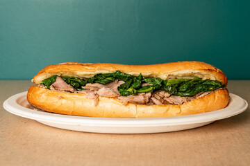 Roasted pork with spinach and cheese sandwich