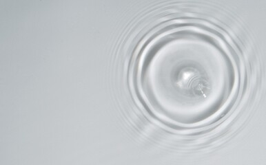 Water drop Ripple Flow sunlight top view transparent clear water white background. Circle wave water surface texture ripples, bubble, splashes. 