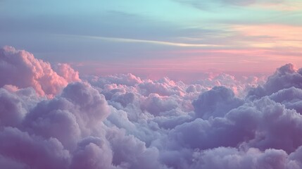 A serene view of fluffy clouds bathed in soft pastel colors during a peaceful sunset or sunrise.