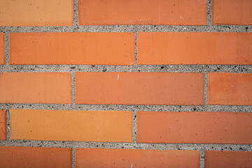 Obraz premium Primer plano de muro de ladrillo naranja con líneas de cemento gris