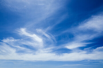 Blue sky with feathery clouds.