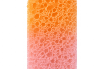 Textured cleaning sponge, orange-pink gradient, close-up view against transparent backdrop revealing intricate surface details